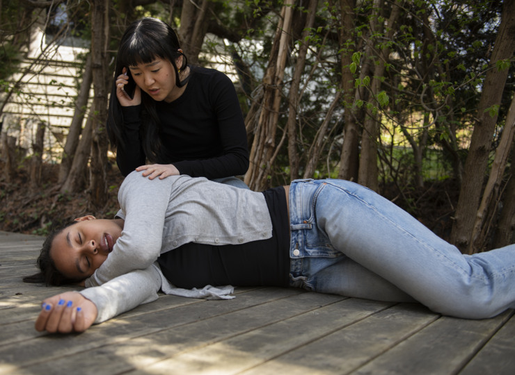 Woman helping an unconscious person. 